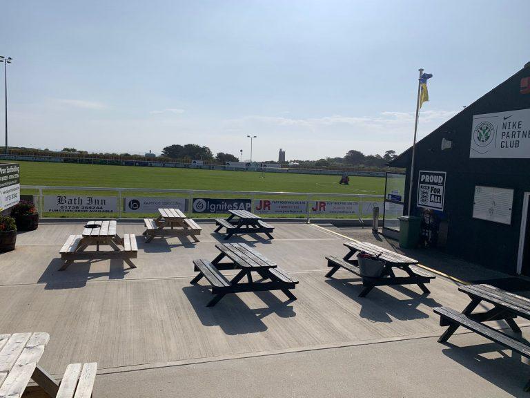 Terrace area with picnic benches at Mousehole AFC clubhouse